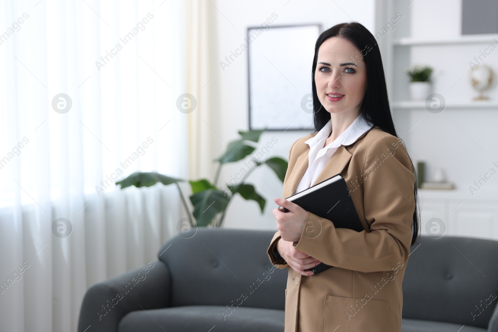 Professional psychologist with notebook in office, space for text Photo of Professional psychologist with notebook in office, space for text