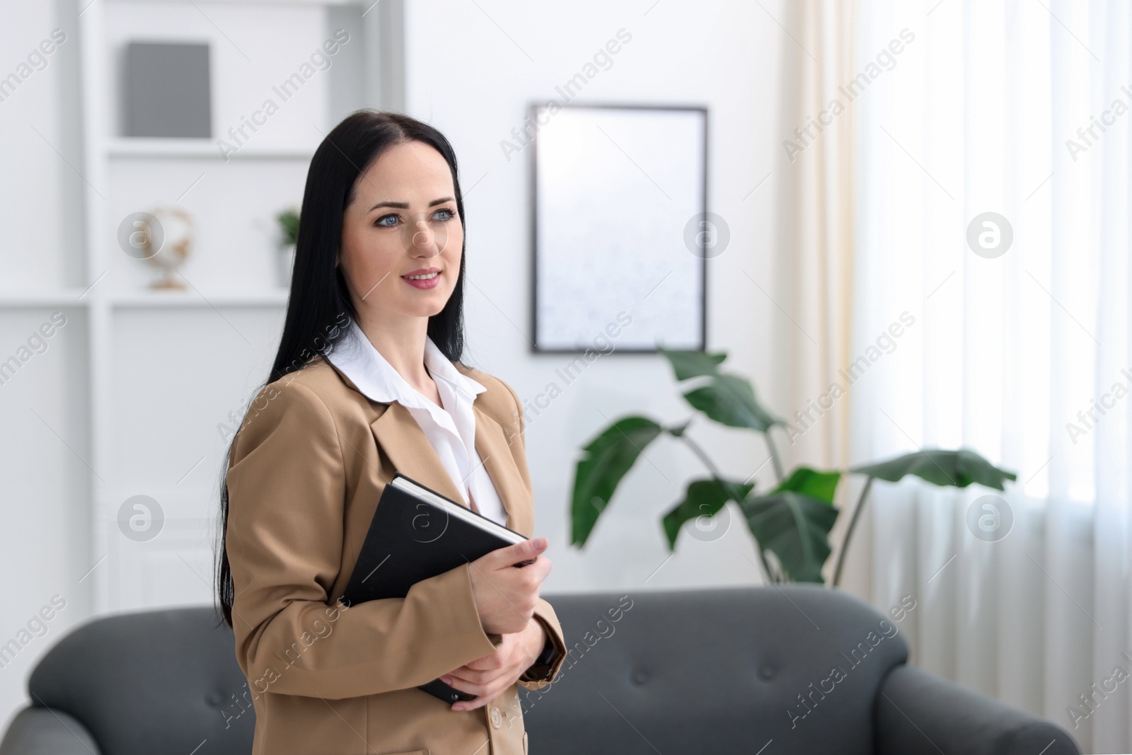 Professional psychologist with notebook in office, space for text Photo of Professional psychologist with notebook in office, space for text