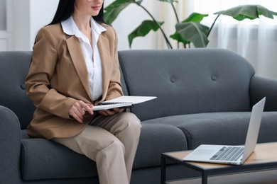 Photo of Professional psychologist with notebook and laptop in office, closeup