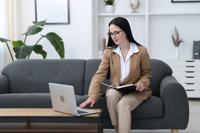 Photo of Professional psychologist working with laptop in office