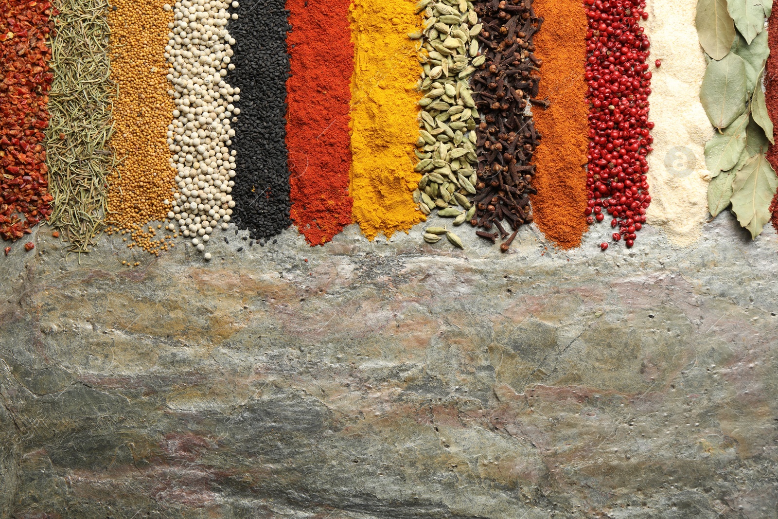 Many different spices on textured table, flat lay. Space for text Photo of Many different spices on textured table, flat lay. Space for text