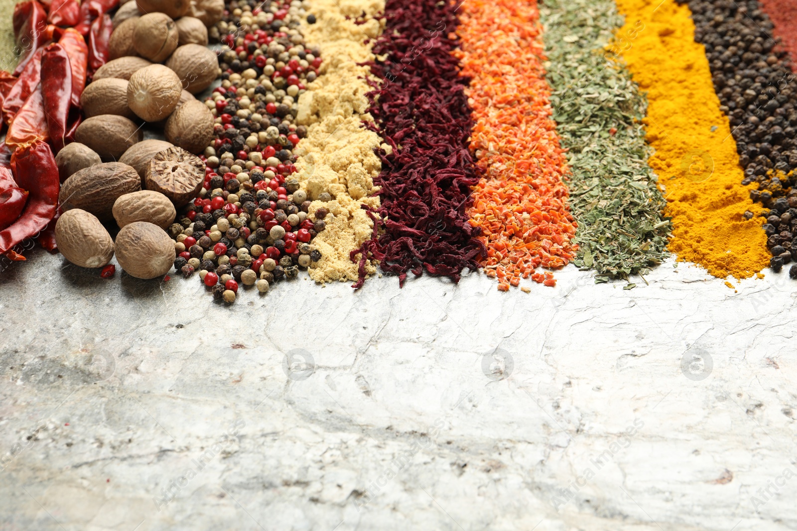 Many different spices on textured table, closeup. Space for text Photo of Many different spices on textured table, closeup. Space for text