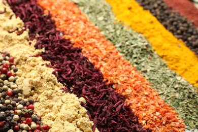 Photo of Many different spices as background, closeup view