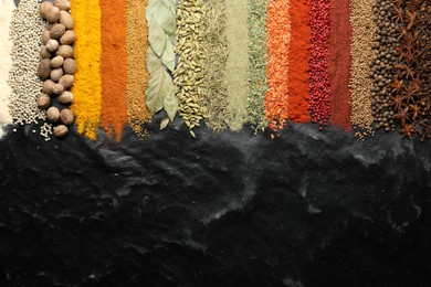 Photo of Many different spices on black table, flat lay. Space for text