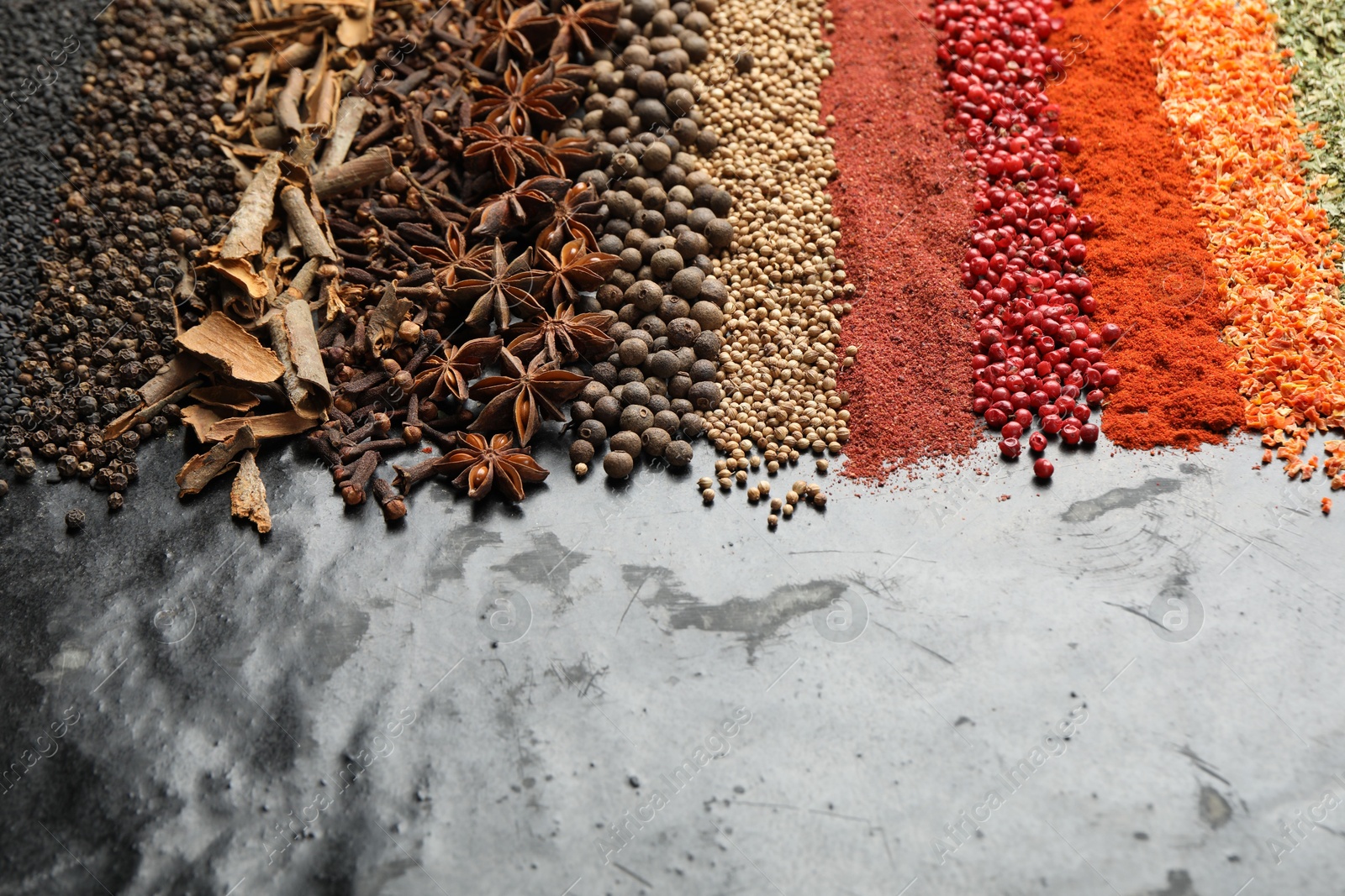 Many different spices on black table, closeup. Space for text Photo of Many different spices on black table, closeup. Space for text