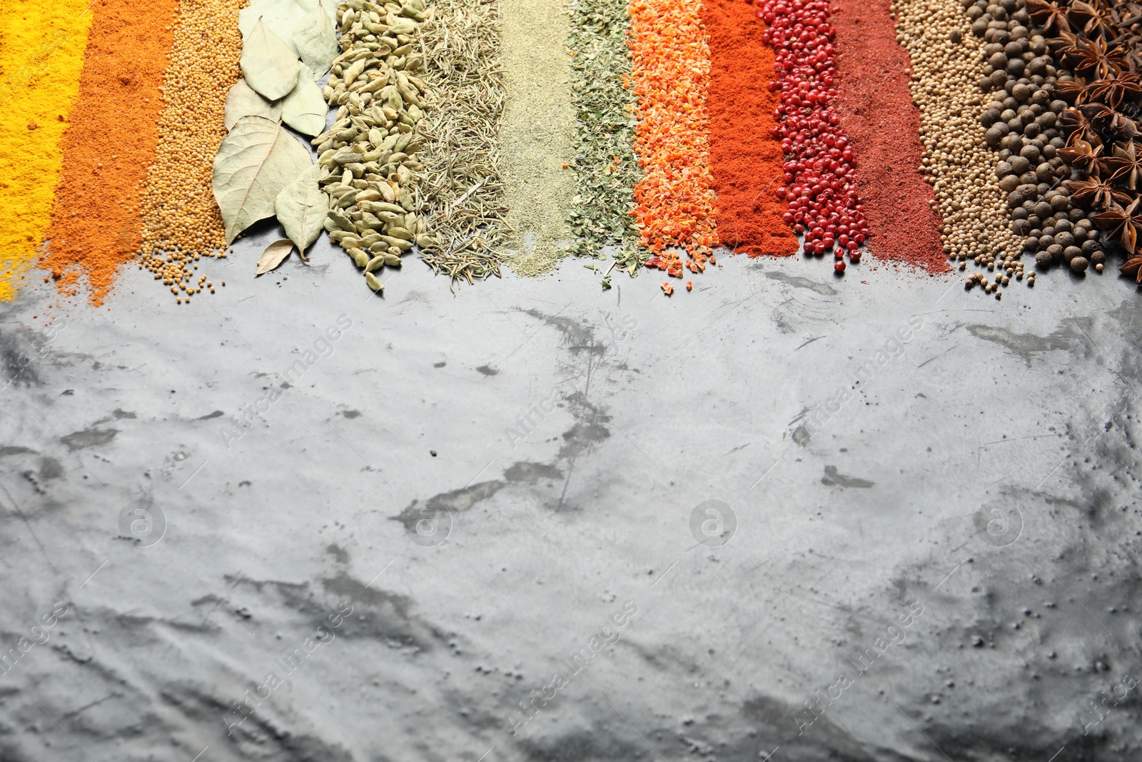 Many different spices on black table, closeup. Space for text Photo of Many different spices on black table, closeup. Space for text