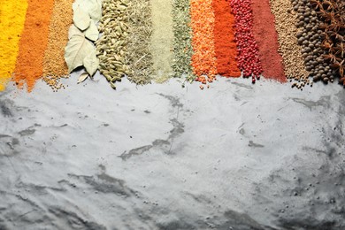 Photo of Many different spices on black table, closeup. Space for text