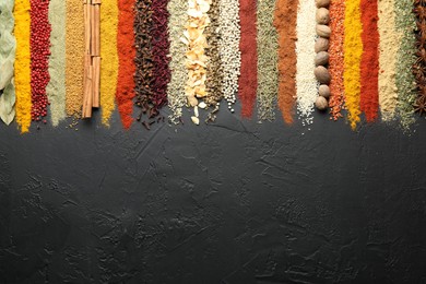 Photo of Many different spices on black table, flat lay. Space for text
