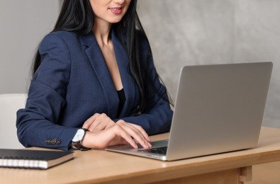 Photo of Professional psychologist working with laptop at table in office, closeup
