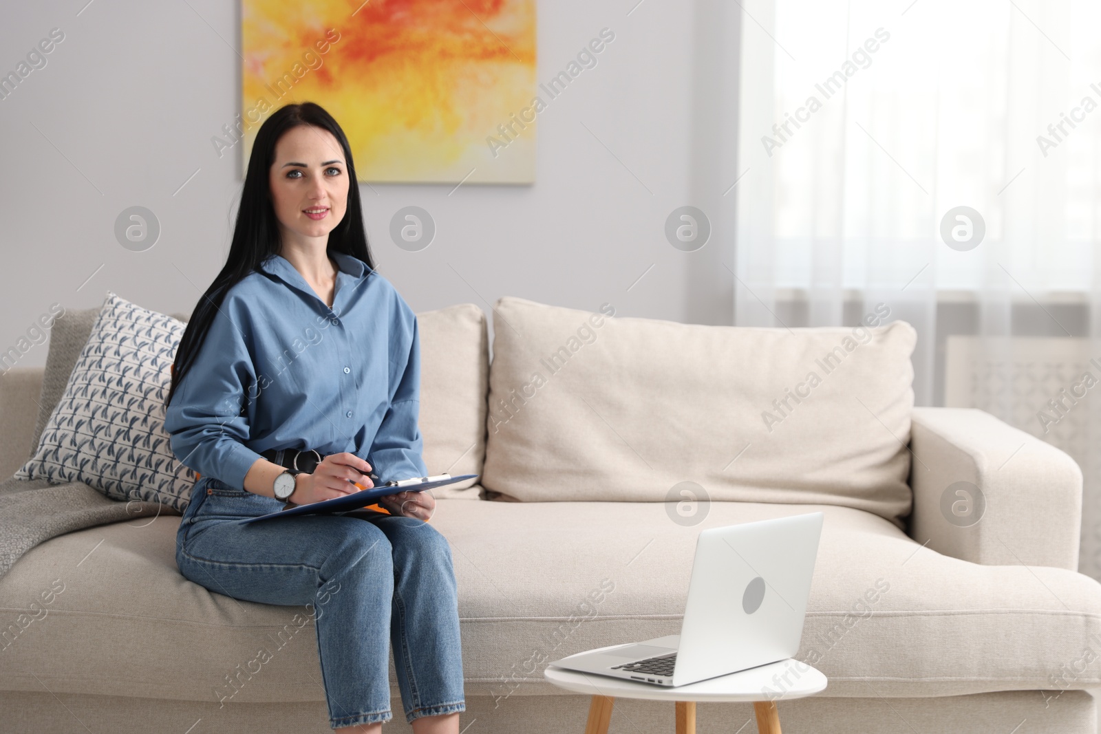 Professional psychologist with clipboard and pen in office Photo of Professional psychologist with clipboard and pen in office