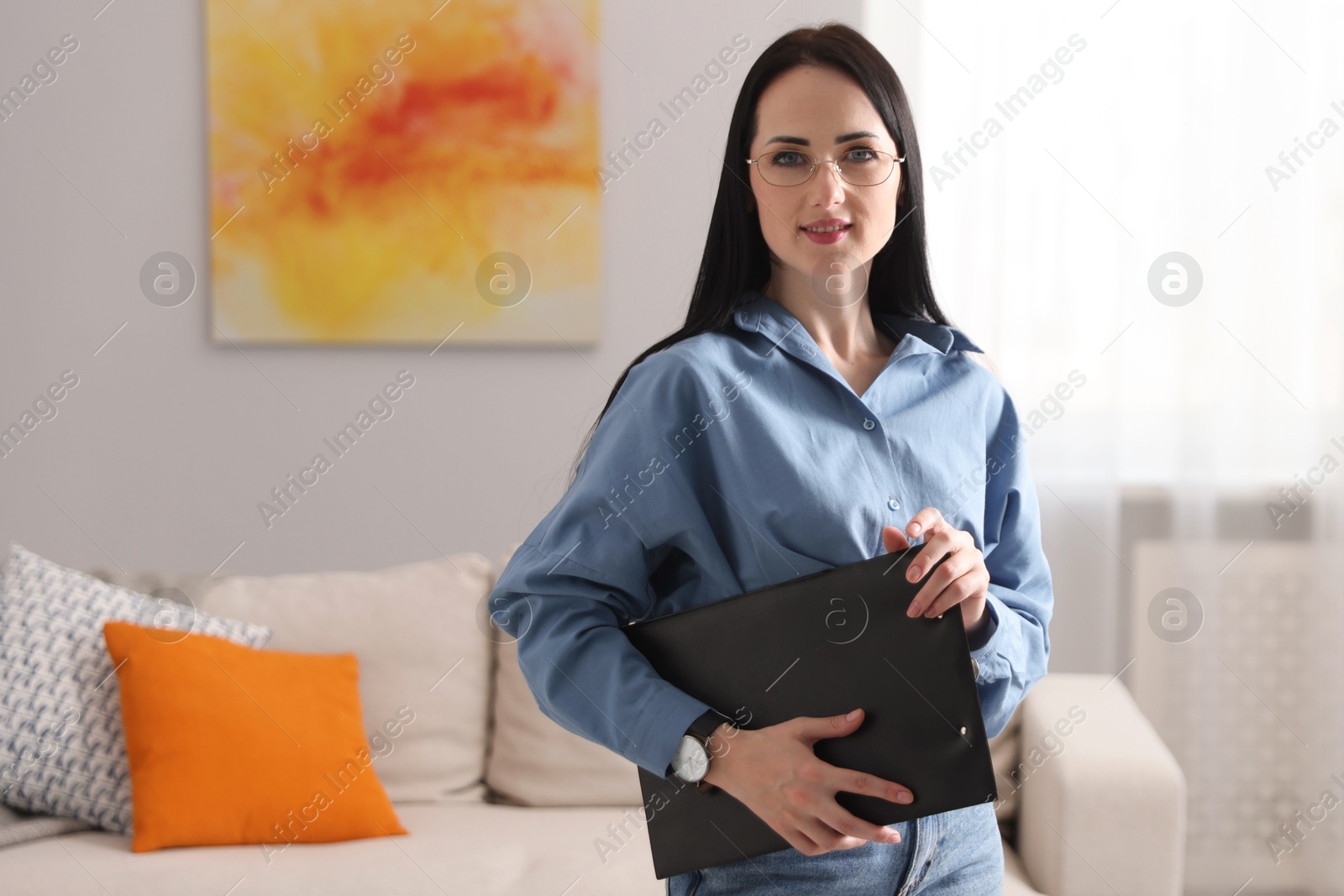 Professional psychologist with clipboard in office, space for text Photo of Professional psychologist with clipboard in office, space for text
