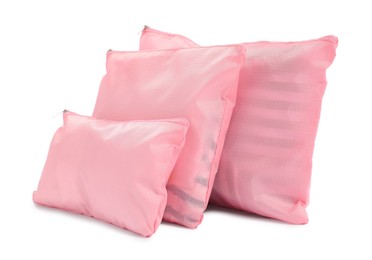 Photo of Pink packing bags isolated on white. Storage organizer