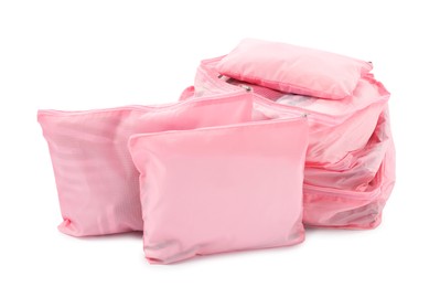 Photo of Pink packing cubes isolated on white. Storage organizer
