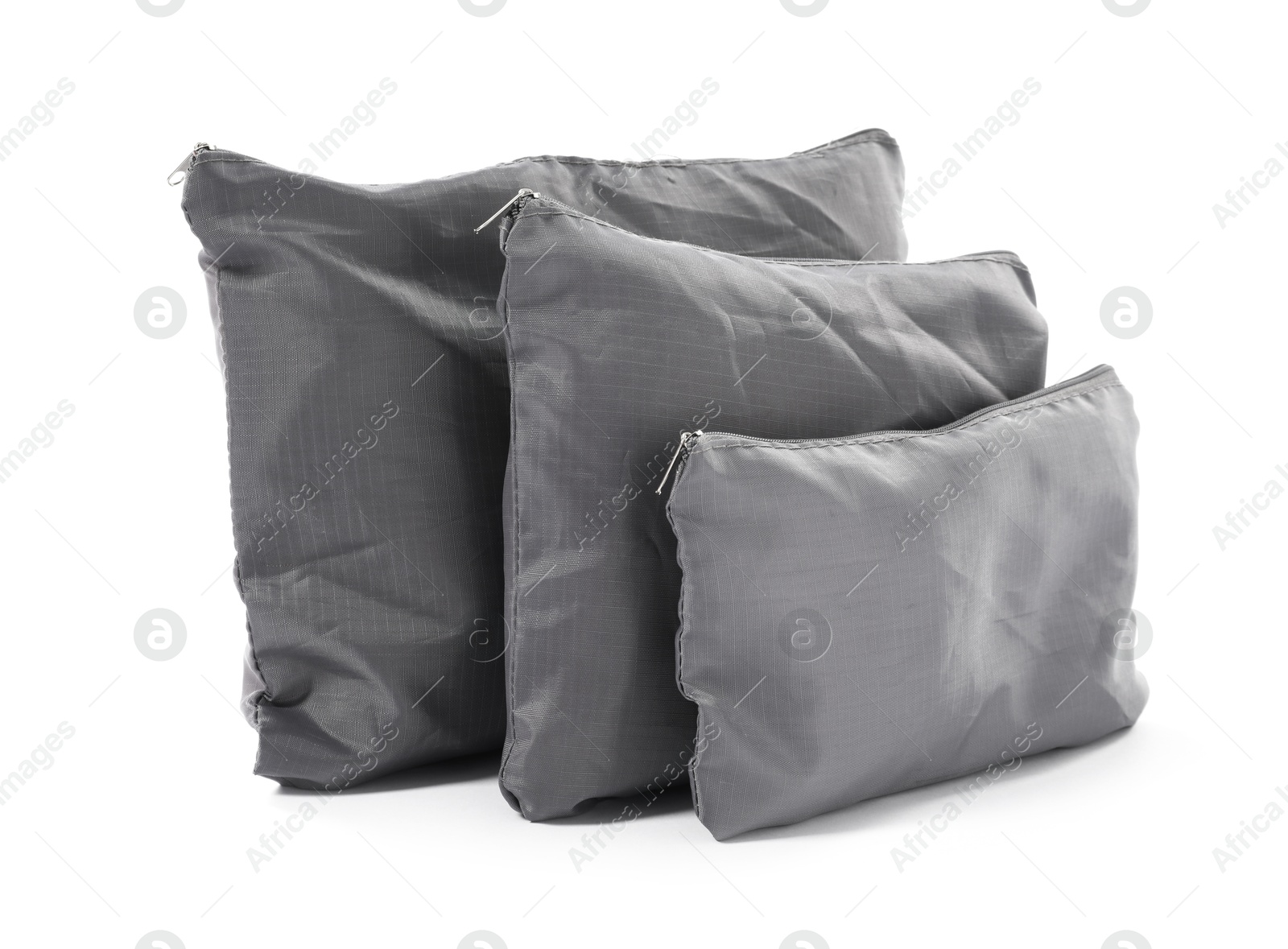 Grey packing bags isolated on white. Storage organizer Photo of Grey packing bags isolated on white. Storage organizer