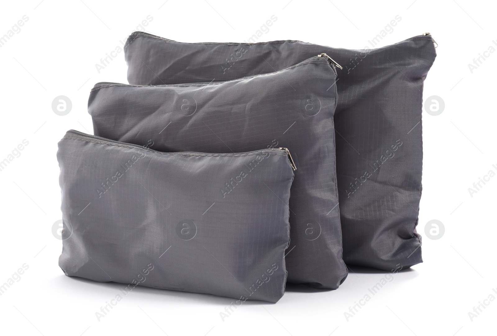 Grey packing bags isolated on white. Storage organizer Photo of Grey packing bags isolated on white. Storage organizer