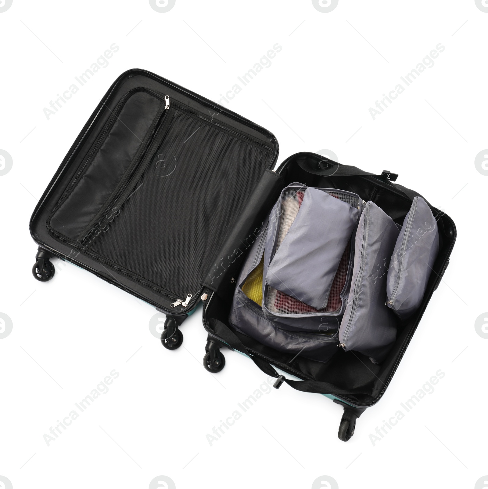 Open suitcase with packing cubes isolated on white, top view Photo of Open suitcase with packing cubes isolated on white, top view