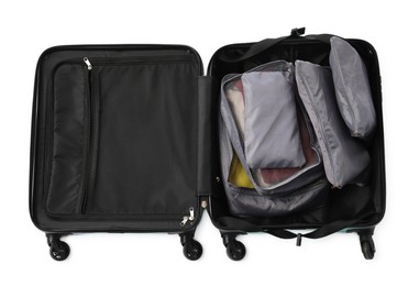 Photo of Open suitcase with packing cubes isolated on white, top view