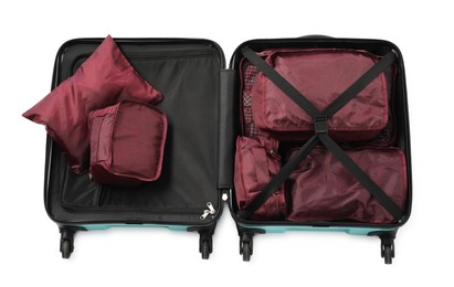Photo of Open suitcase with packing cubes isolated on white, top view