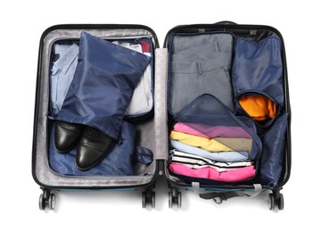 Photo of Open suitcase with packing cubes isolated on white, top view