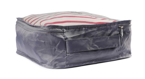 Photo of Packing cube with folded clothes isolated on white