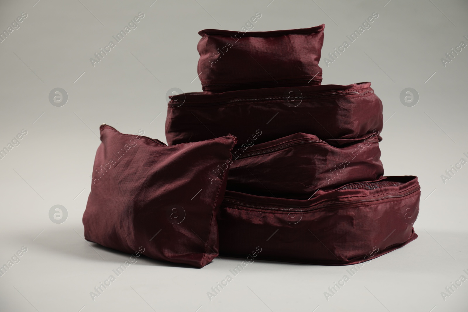 Packing cubes with clothes on light grey background Photo of Packing cubes with clothes on light grey background