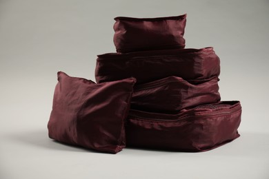Photo of Packing cubes with clothes on light grey background