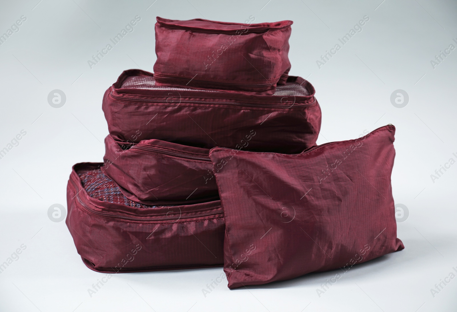 Packing cubes with clothes on white background Photo of Packing cubes with clothes on white background