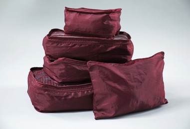 Photo of Packing cubes with clothes on white background