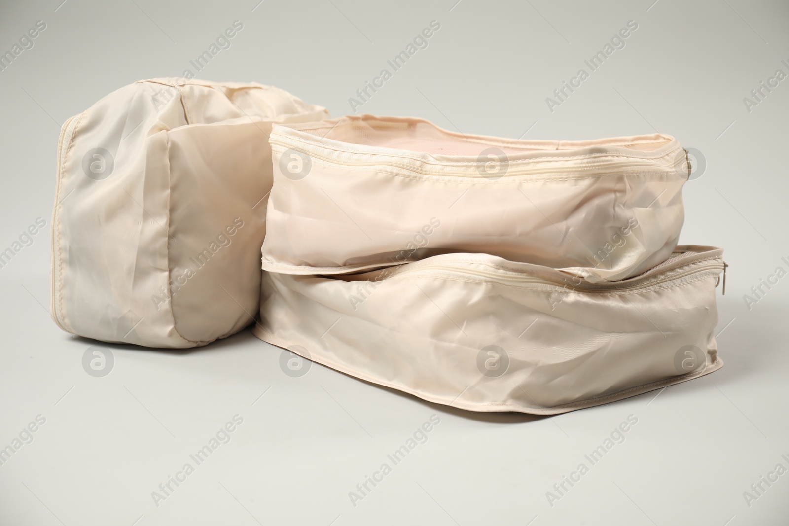 Packing cubes with clothes on light grey background Photo of Packing cubes with clothes on light grey background