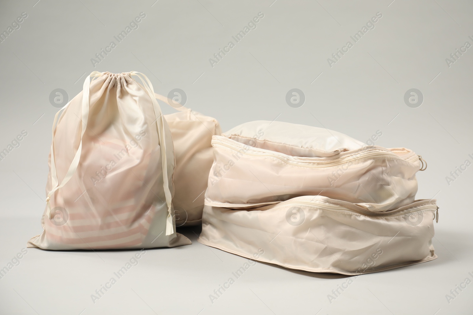 Packing cubes with clothes on light grey background Photo of Packing cubes with clothes on light grey background