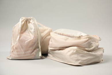 Photo of Packing cubes with clothes on light grey background