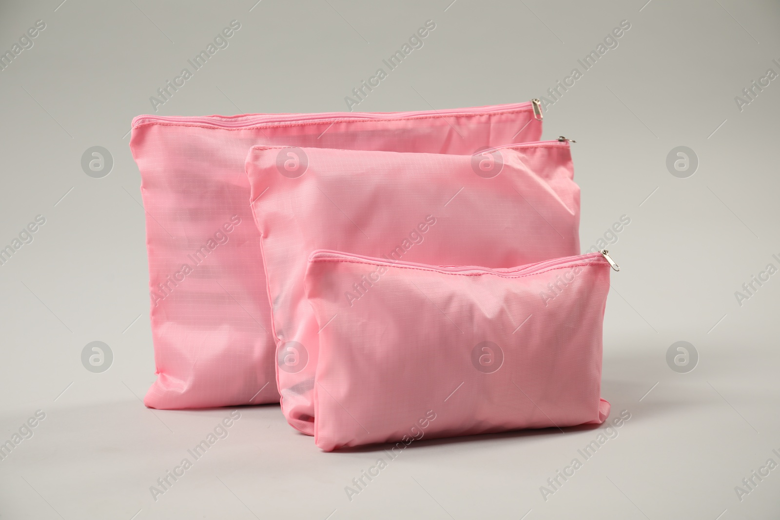 Packing cubes with clothes on light grey background Photo of Packing cubes with clothes on light grey background