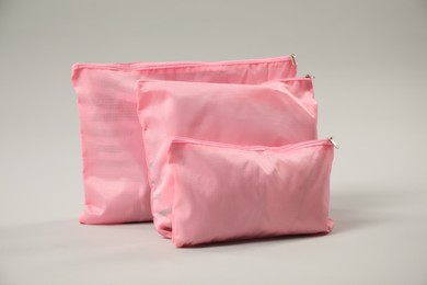 Photo of Packing cubes with clothes on light grey background