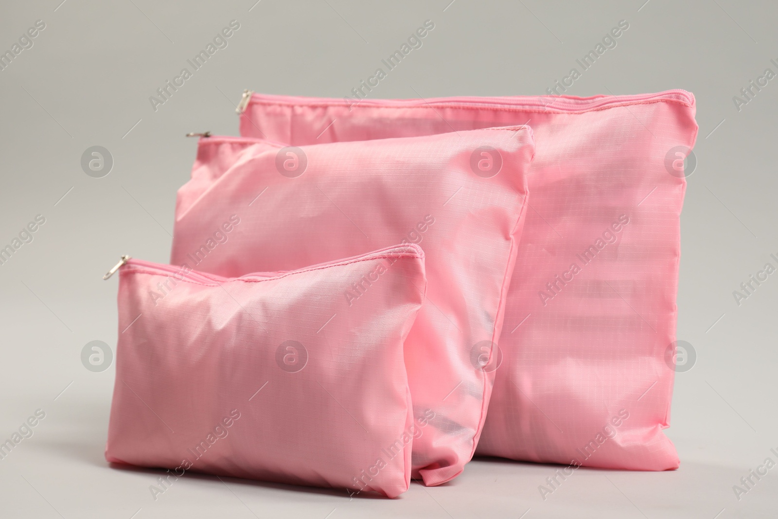 Packing cubes with clothes on light grey background Photo of Packing cubes with clothes on light grey background
