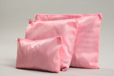 Photo of Packing cubes with clothes on light grey background