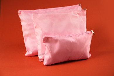 Photo of Packing cubes with clothes on bright orange background