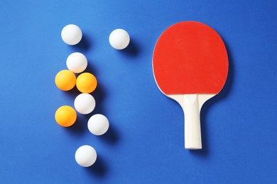 Photo of Ping pong racket and balls on blue background, flat lay