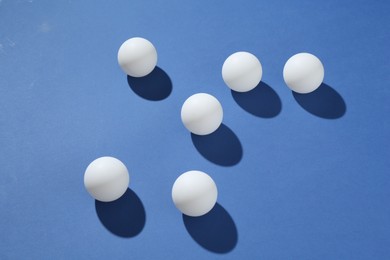 Photo of Many ping pong balls on blue background
