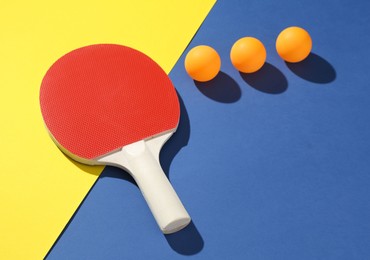 Photo of Ping pong racket and balls on color background
