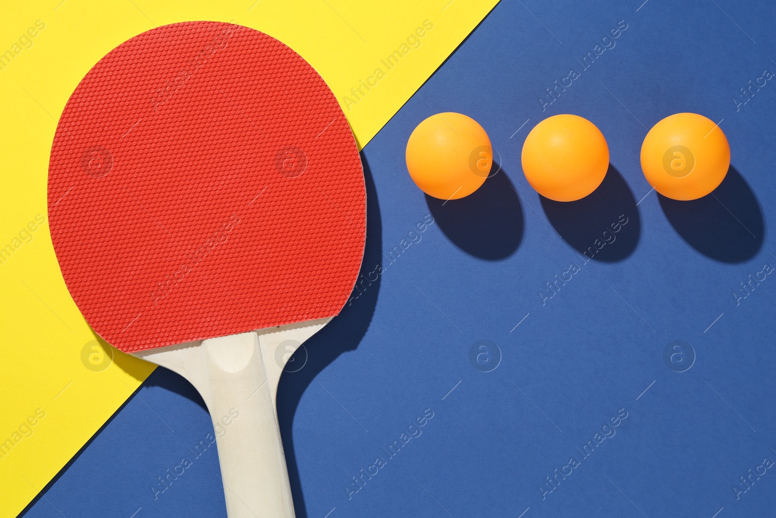 Ping pong racket and balls on color background, flat lay Photo of Ping pong racket and balls on color background, flat lay