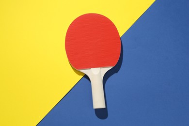 Photo of One ping pong racket on color background, top view