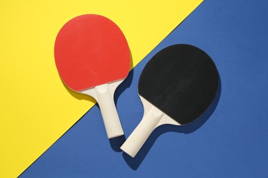 Photo of Ping pong rackets on color background, top view