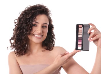 Photo of Smiling woman with eyeshadow palette on white background