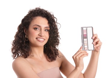 Photo of Smiling woman with eyeshadow palette on white background