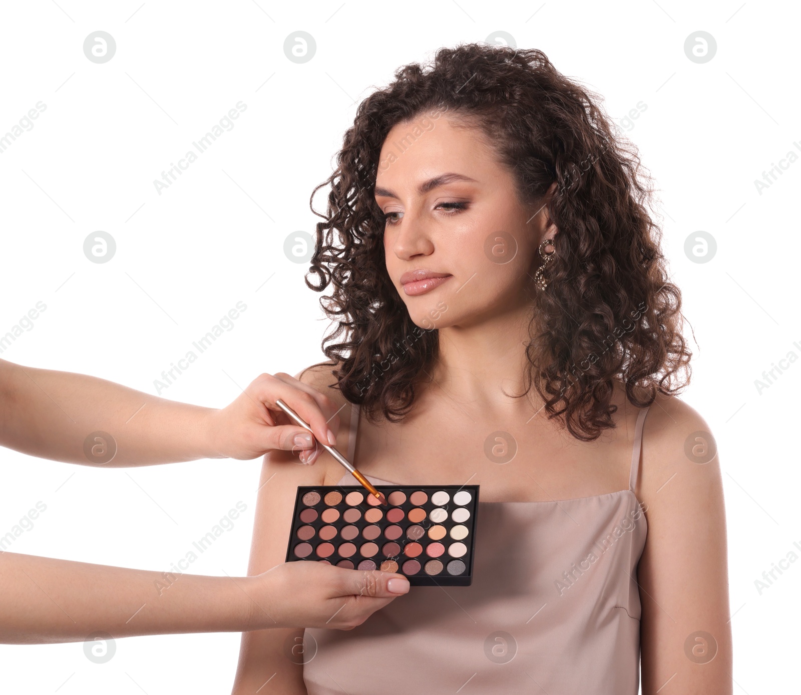 Makeup artist applying eyeshadows onto woman's face on white background, closeup Photo of Makeup artist applying eyeshadows onto woman's face on white background, closeup