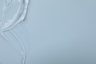 Photo of Collagen gel on light blue background, top view. Space for text