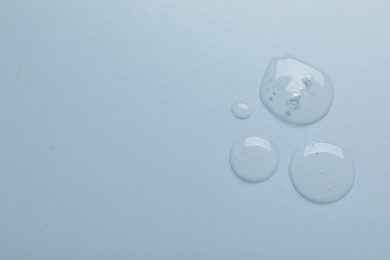 Photo of Collagen gel on light blue background, top view. Space for text