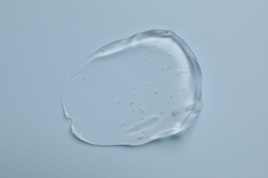 Photo of Collagen gel on light blue background, top view