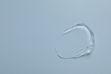Photo of Collagen gel on light blue background, top view. Space for text