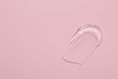 Photo of Collagen gel on pink background, top view. Space for text